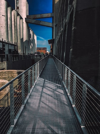 Close-up of a sturdy catwalk installed along the side of a tall silo, showcasing precise metalwork.