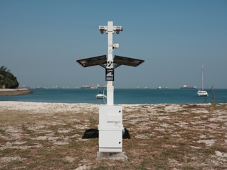 white cross on beach shore during daytime
