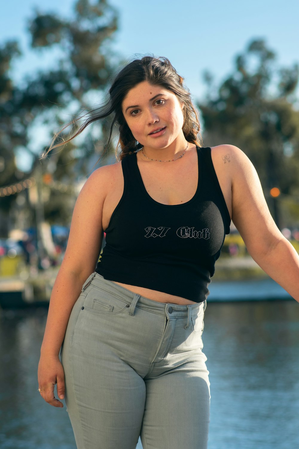 woman in black tank top and white denim shorts