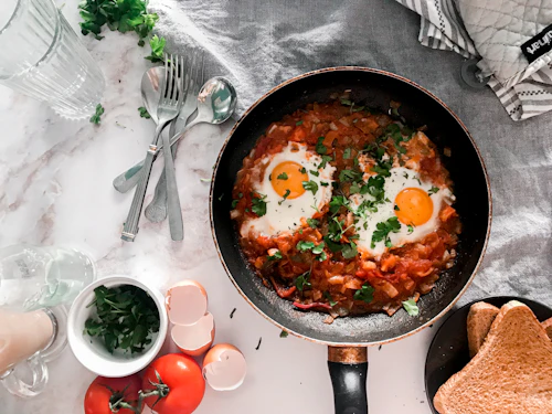 Shakshuka with baked eggs in a tomato pepper sauce