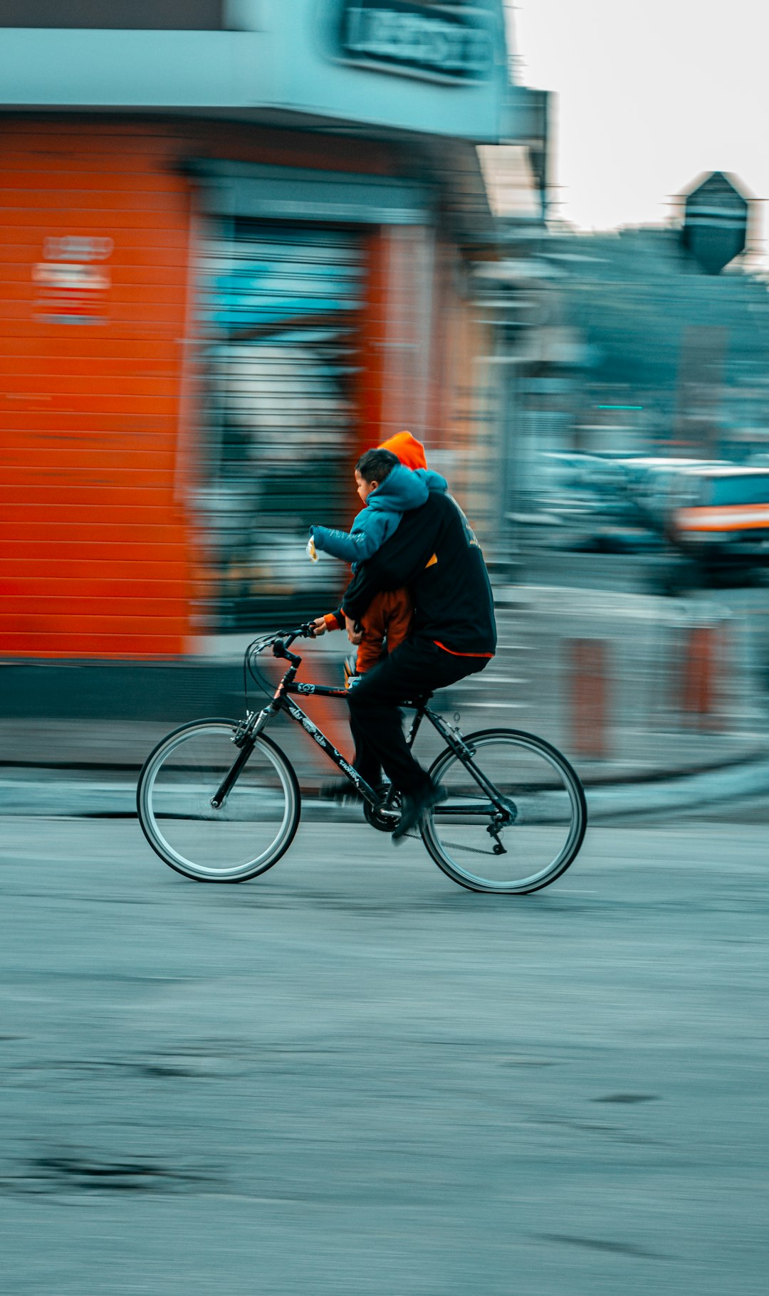 man in black jacket riding on black bicycle