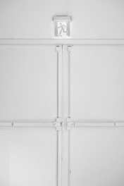 Image showing safety and evacuation signs clearly displayed in an industrial setting.