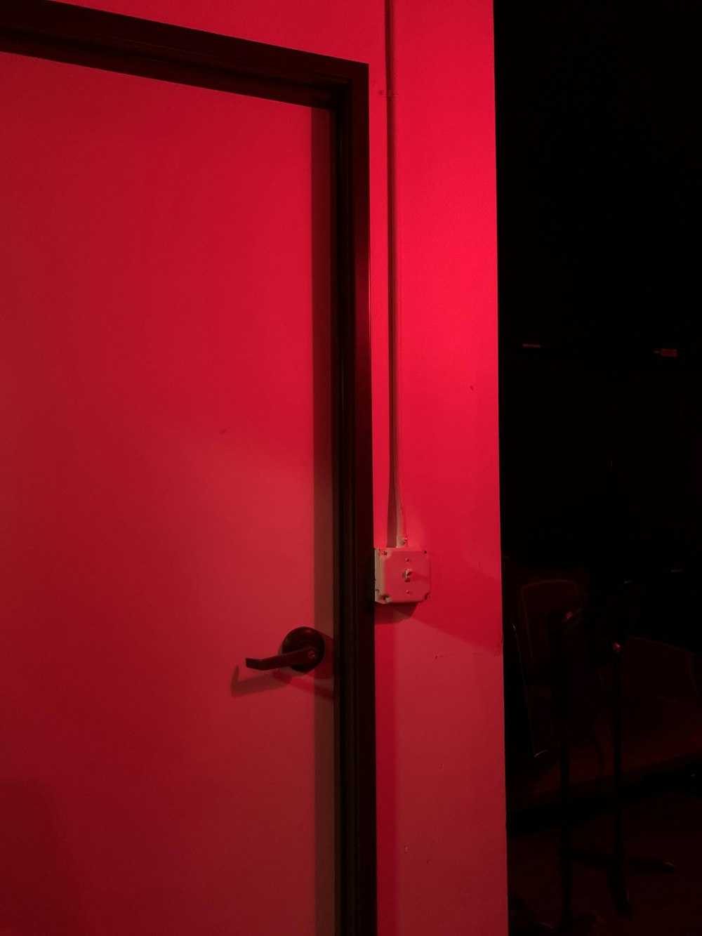 red wooden door with silver door lever