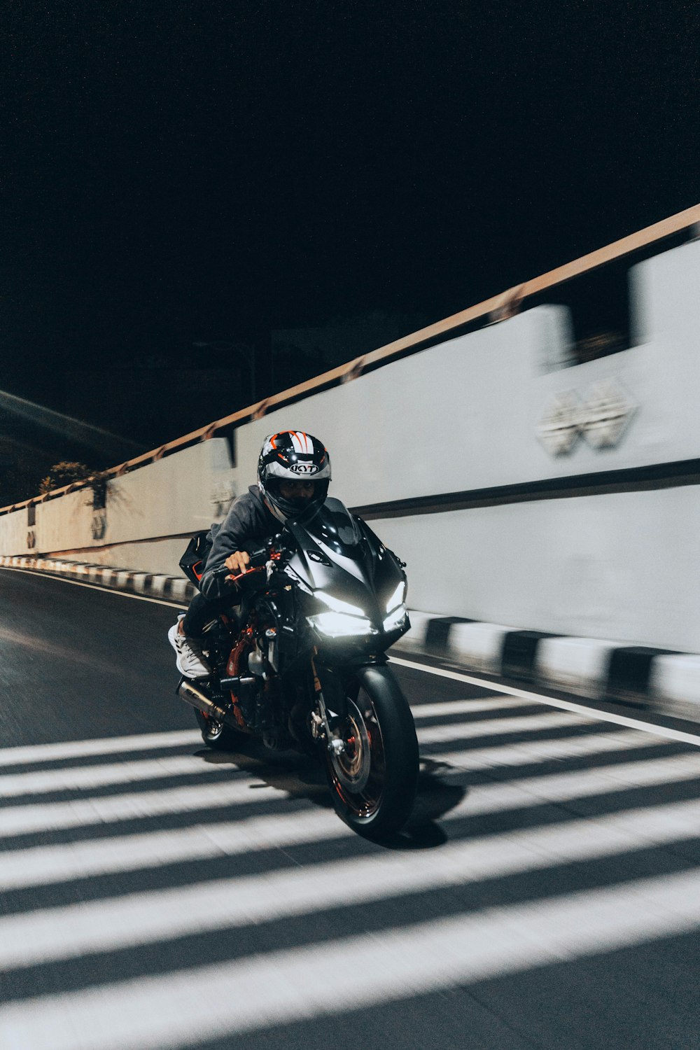 man in black motorcycle helmet riding motorcycle