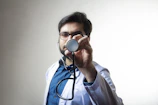 Smiling male doctor wearing a white coat and stethoscope.