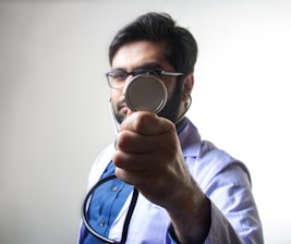 person in white long sleeve shirt holding magnifying glass