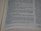 A close-up view of an open book with printed text in English. The focus is on the center of the page, with the text becoming blurred towards the edges. The text is neatly aligned in paragraphs.