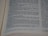 A close-up view of an open book with printed text in English. The focus is on the center of the page, with the text becoming blurred towards the edges. The text is neatly aligned in paragraphs.