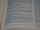 A close-up view of an open book with printed text in English. The focus is on the center of the page, with the text becoming blurred towards the edges. The text is neatly aligned in paragraphs.