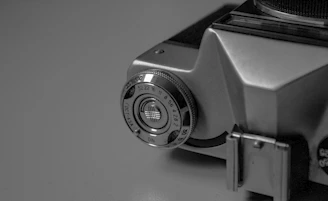 Close-up of a vintage camera aperture with gold accents reflecting studio lights.