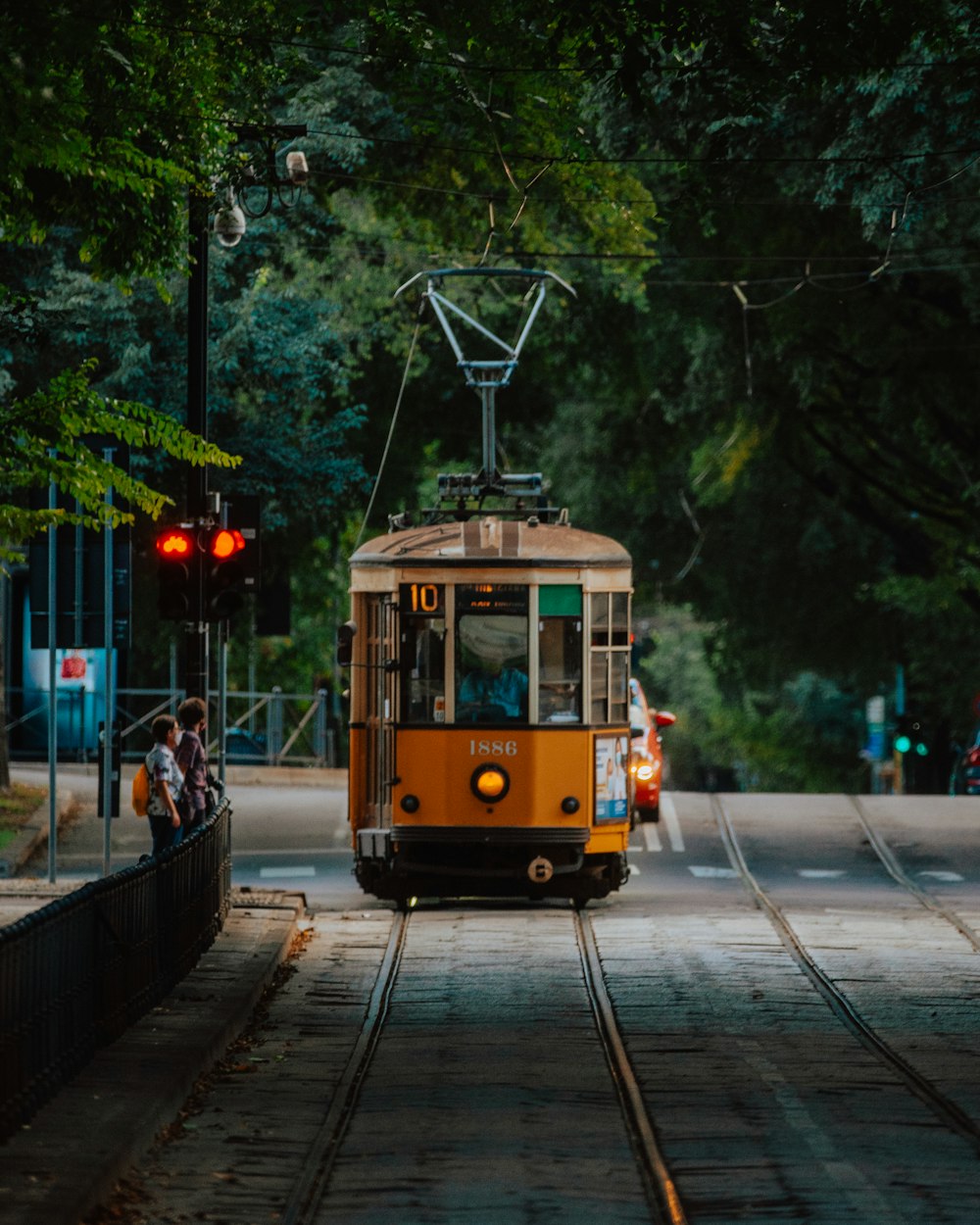 yellow and black tram on road during daytime