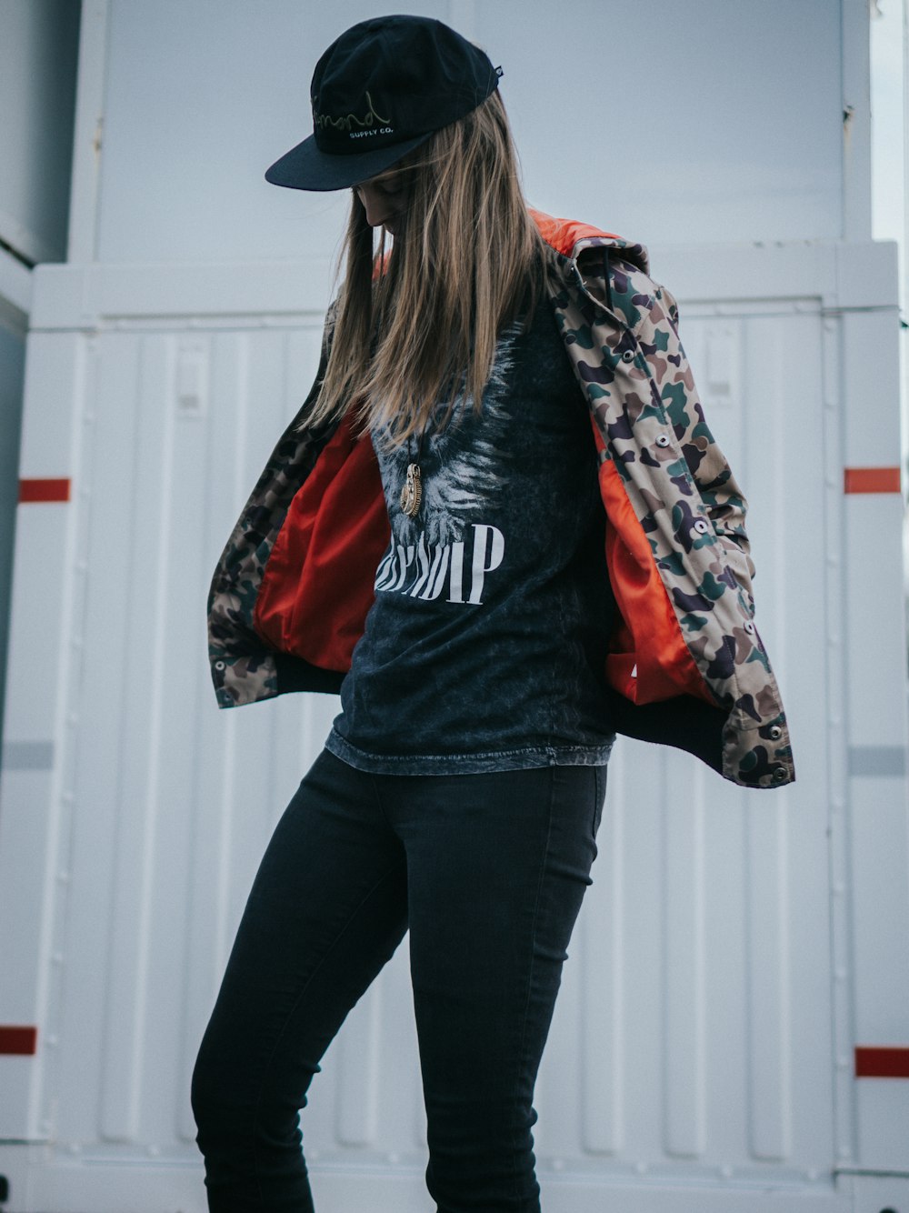 woman in black and red jacket and black pants wearing black cowboy hat