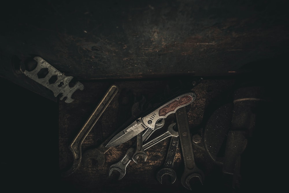 stainless steel hand tool on black wooden table