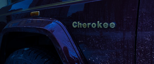 Close-up of a Jeep Grand Cherokee armored vehicle showcasing its reinforced doors and tinted windows.