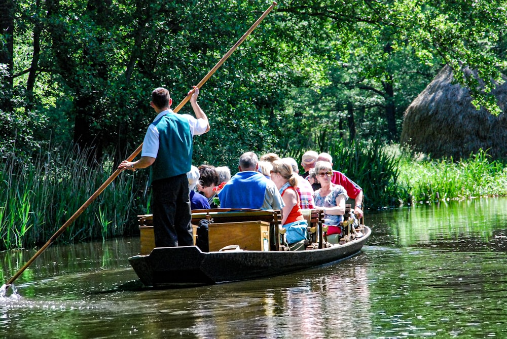 people riding on boat on river during daytime