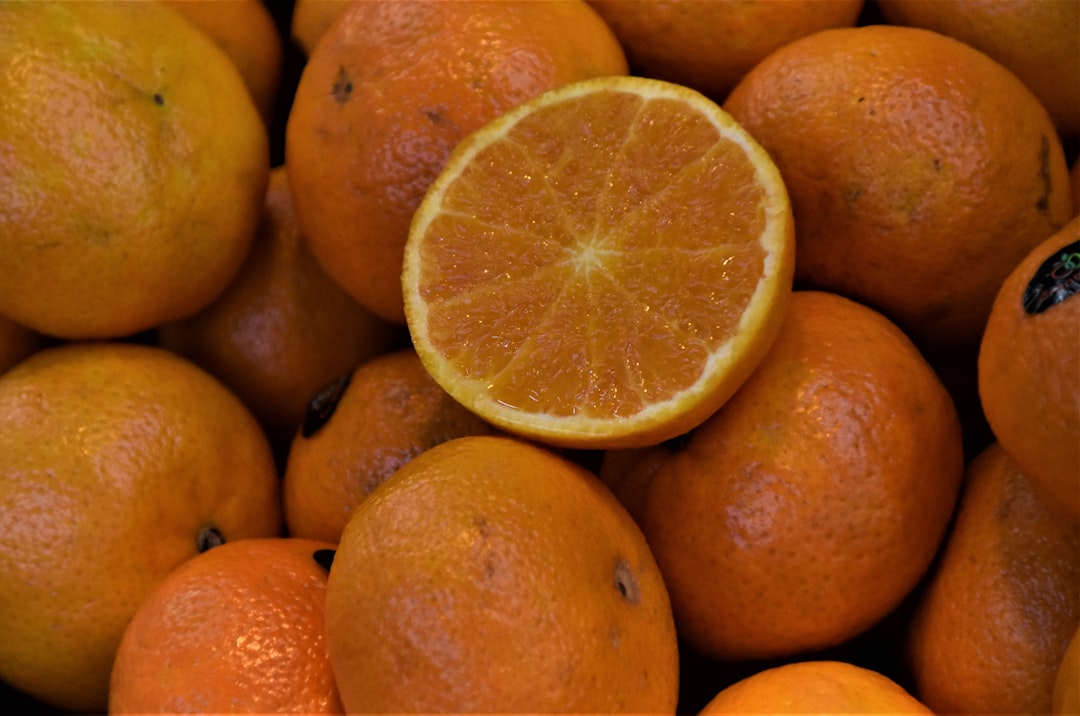 orange fruits on brown wooden shelf