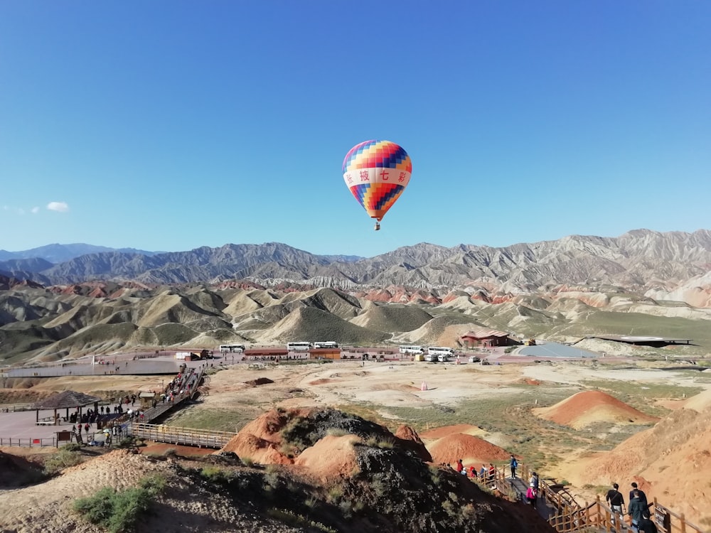 hot air balloon floating over the mountains during daytime