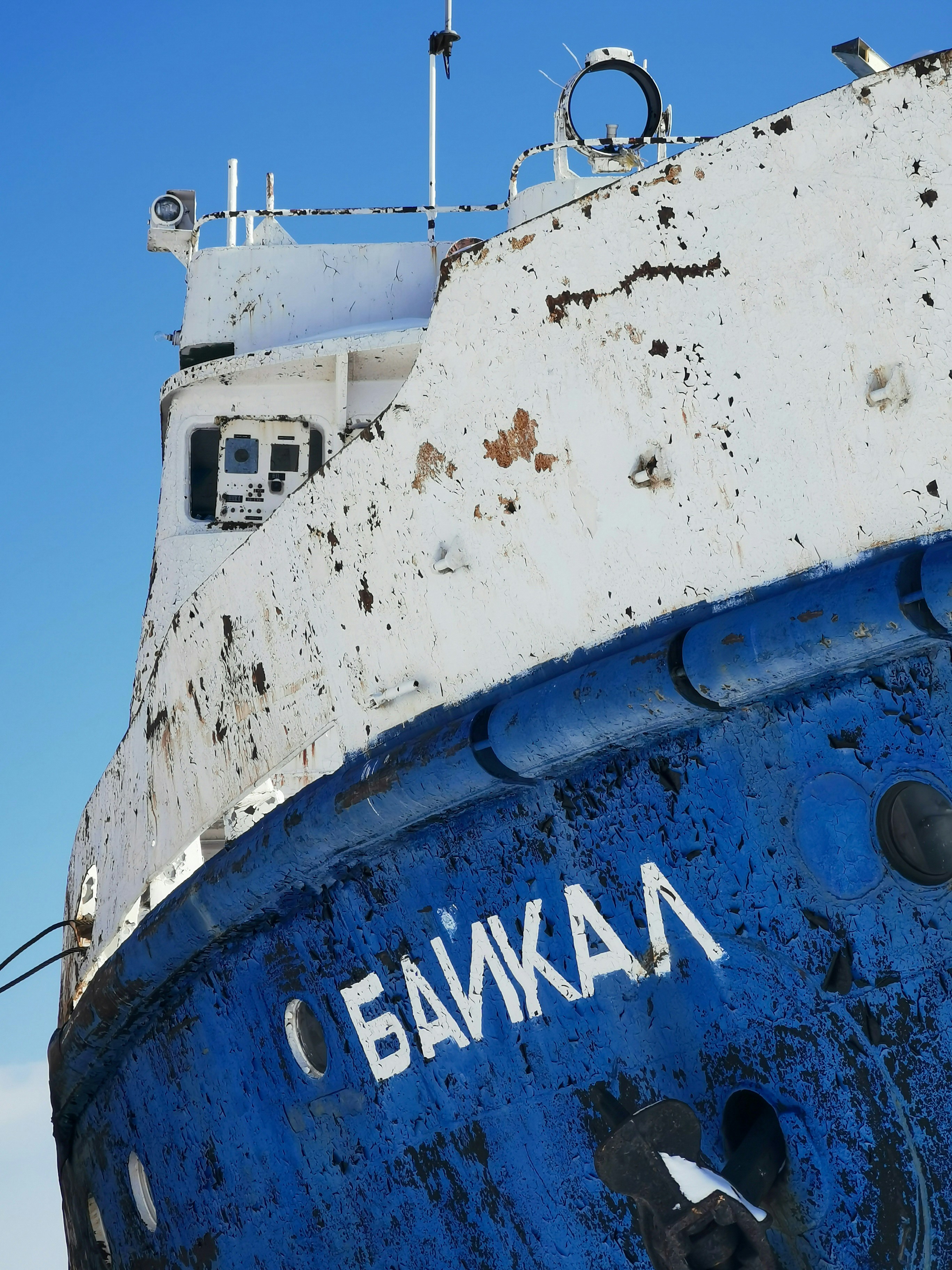 white and blue ship on sea under blue sky during daytime