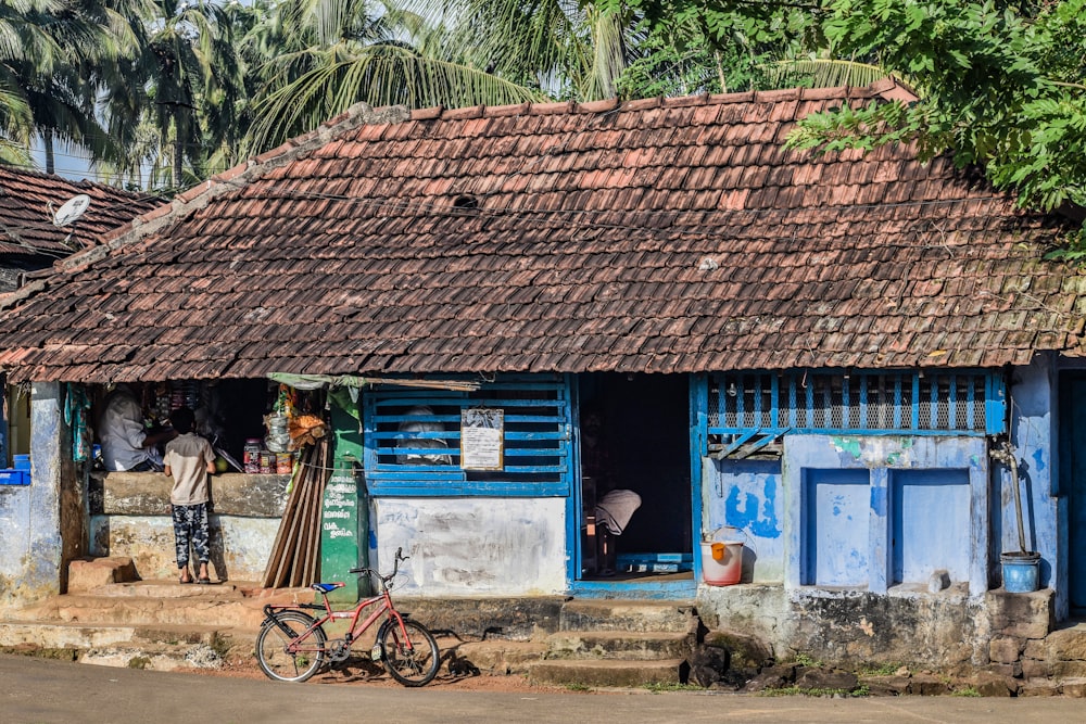 brown wooden house near green trees during daytime