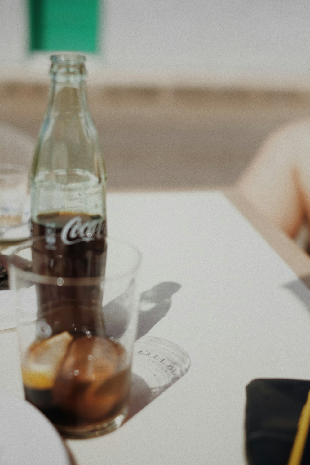 coca cola glass bottle on table