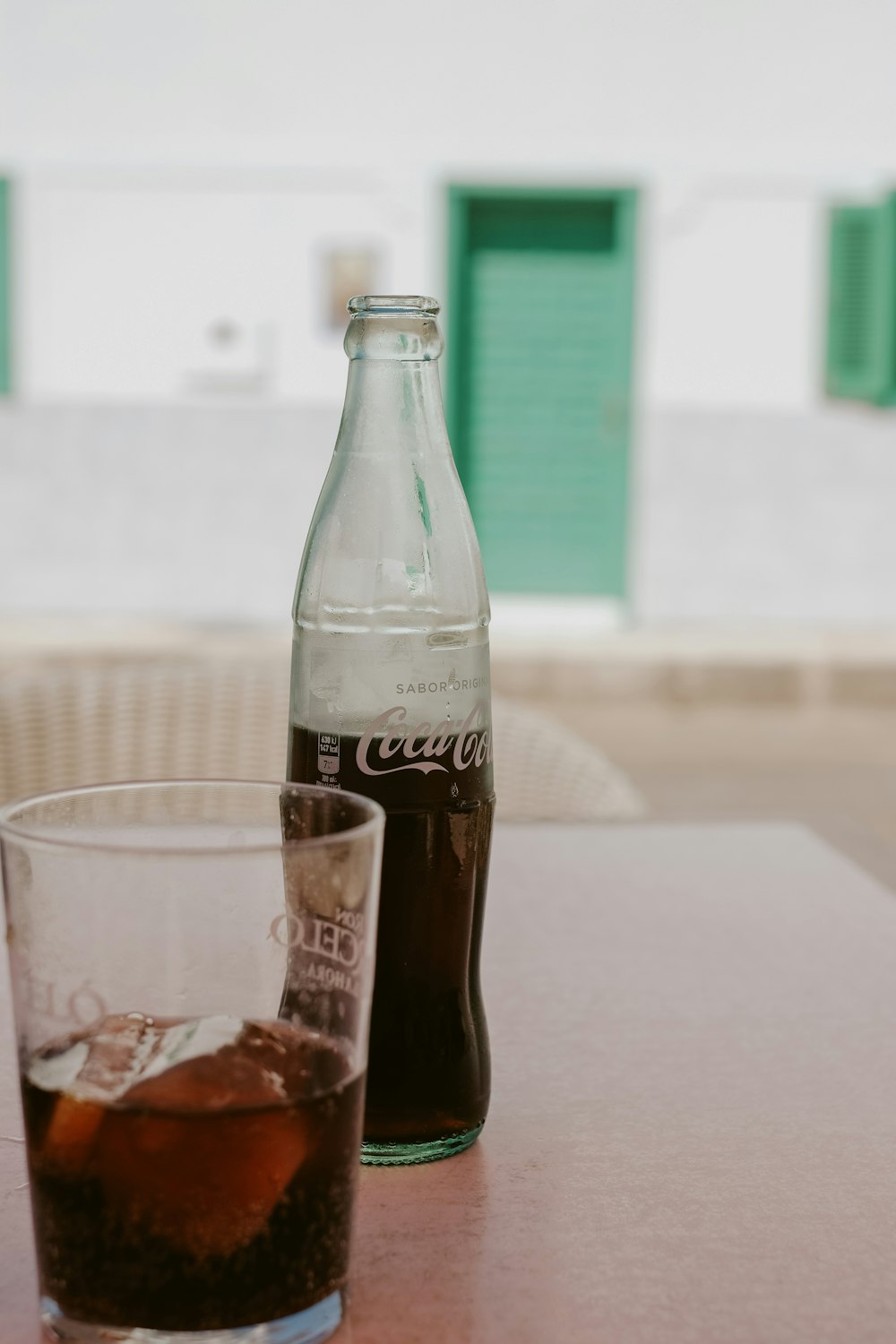 coca cola zero bottle beside clear drinking glass