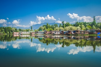 brown wooden houses near body of water under blue sky during daytime