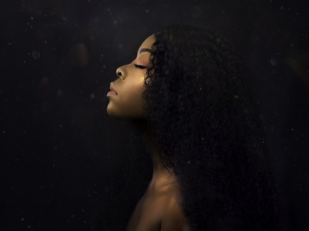 woman with black hair looking at the moon