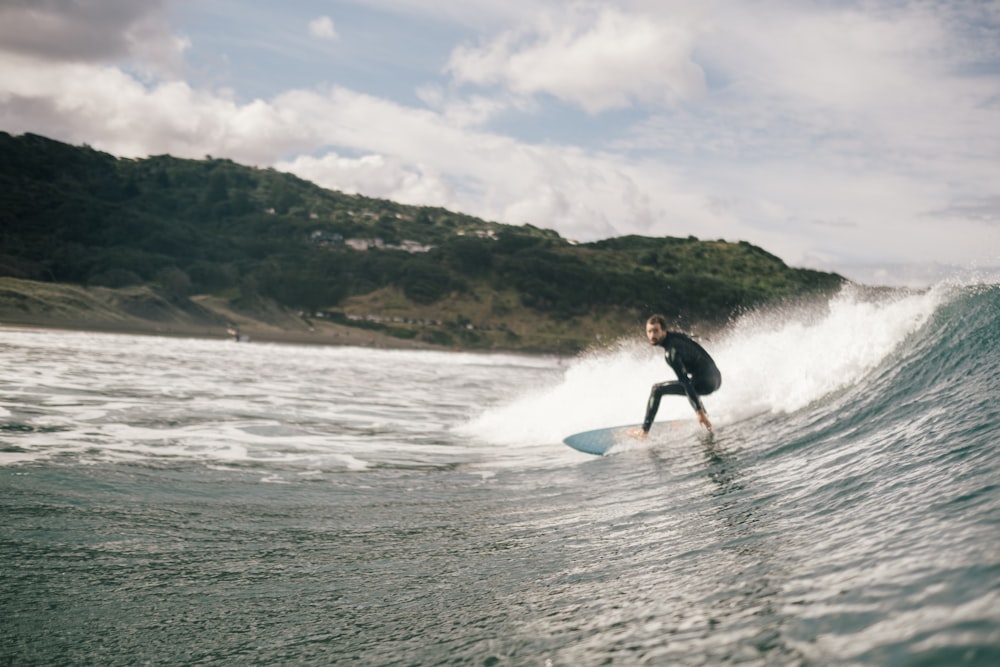 昼間、海でサーフィンをする男性