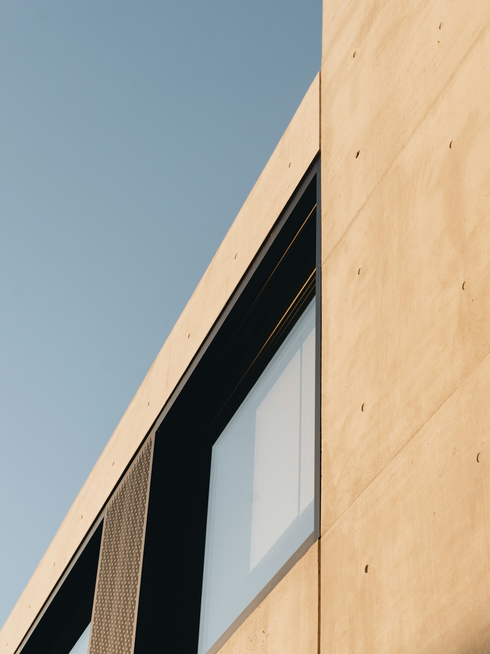 beige concrete building under blue sky during daytime