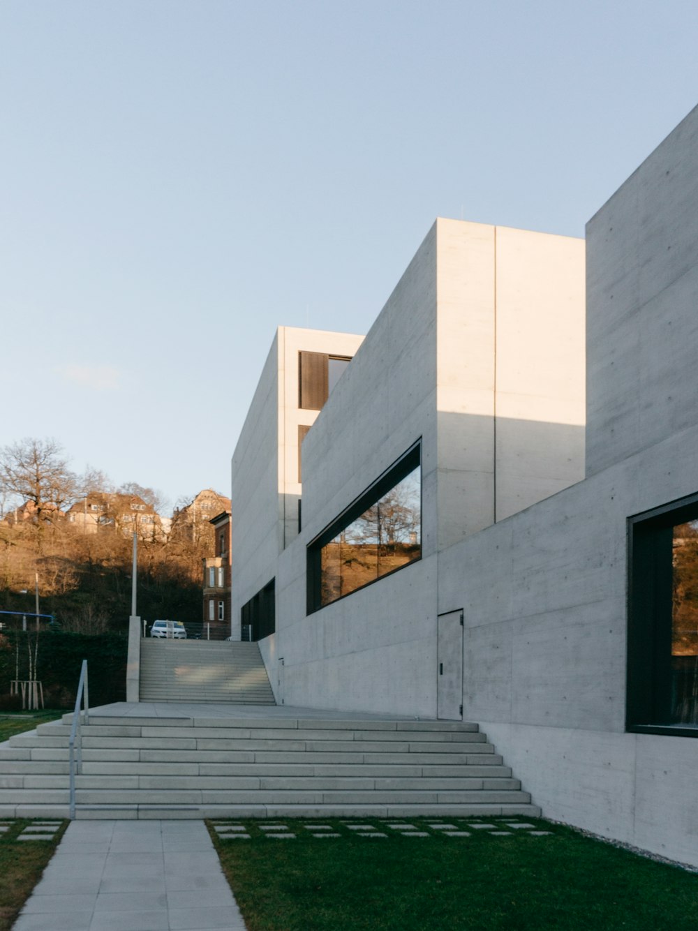 white concrete building near trees during daytime