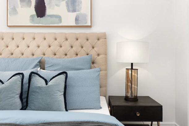 white and black table lamp on brown wooden table
