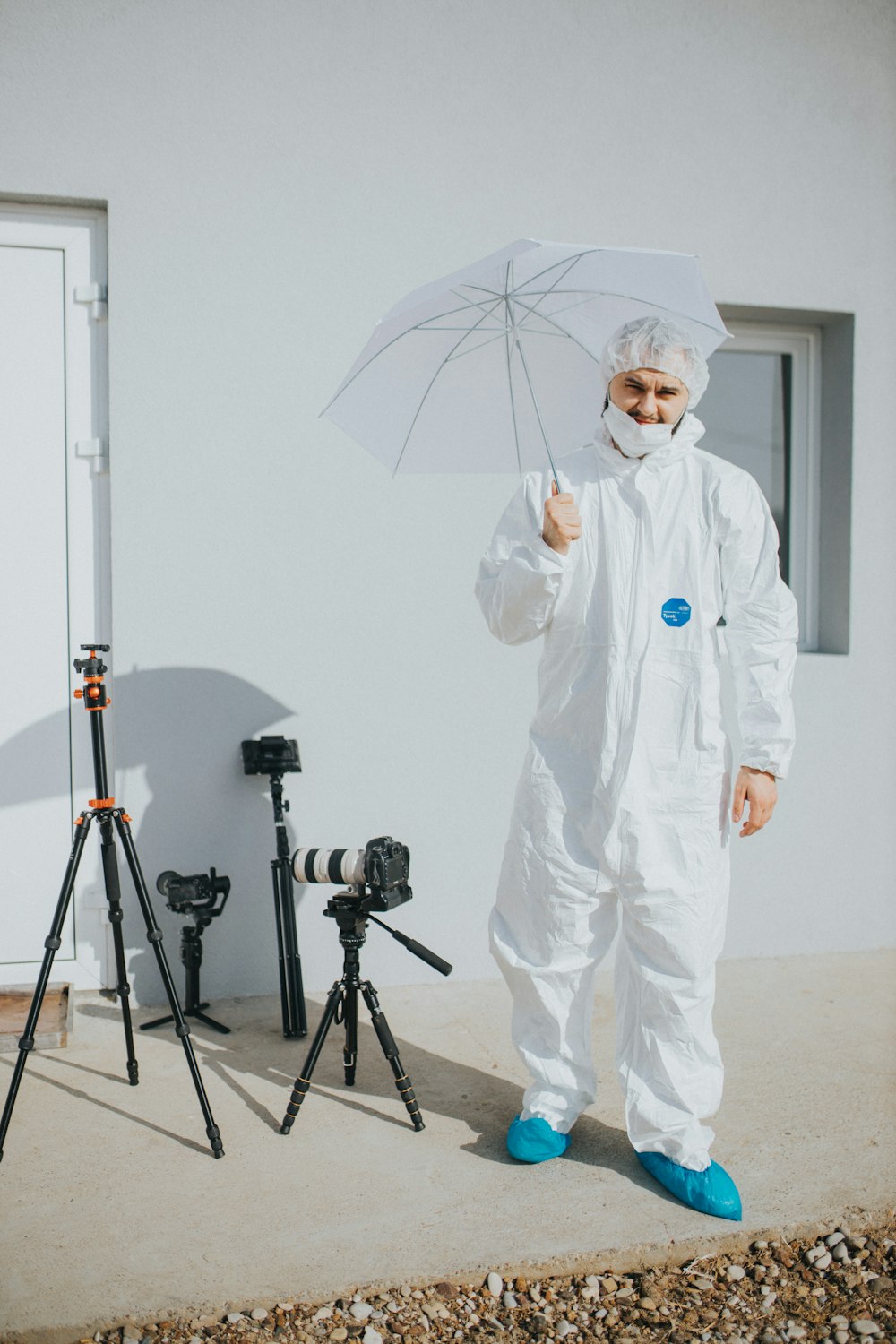 man in white robe holding umbrella