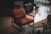 brown and black armchair beside brown wooden table