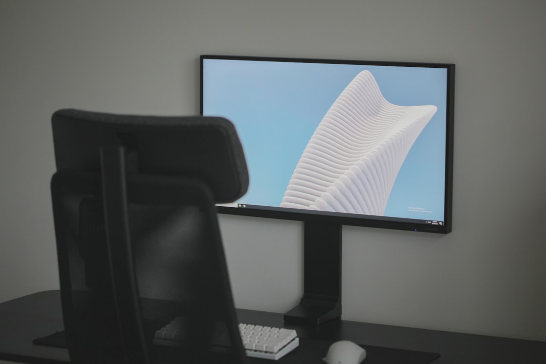 black flat screen computer monitor on white table
