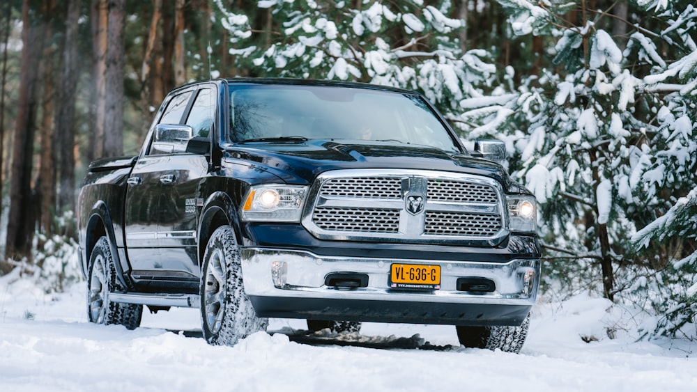 black chevrolet car on snow covered ground