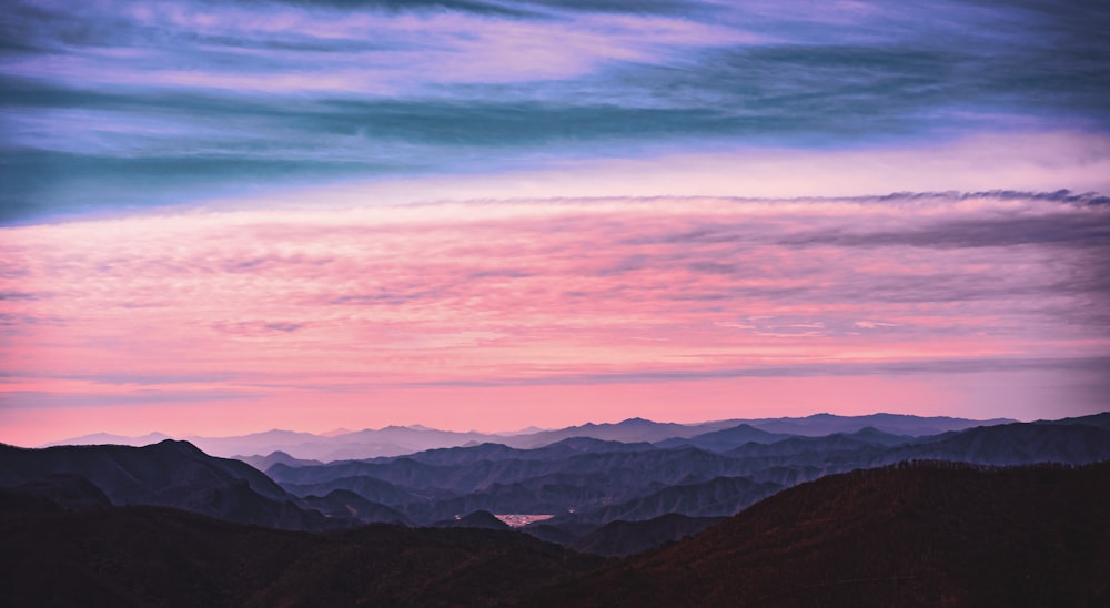 mountains under white clouds during daytime