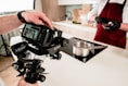 person holding black dslr camera