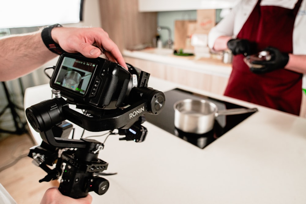 person holding black dslr camera