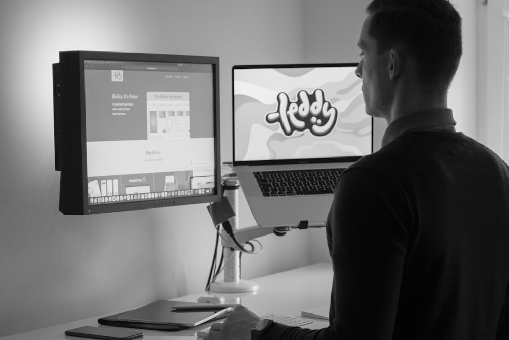 man in black long sleeve shirt sitting in front of computer