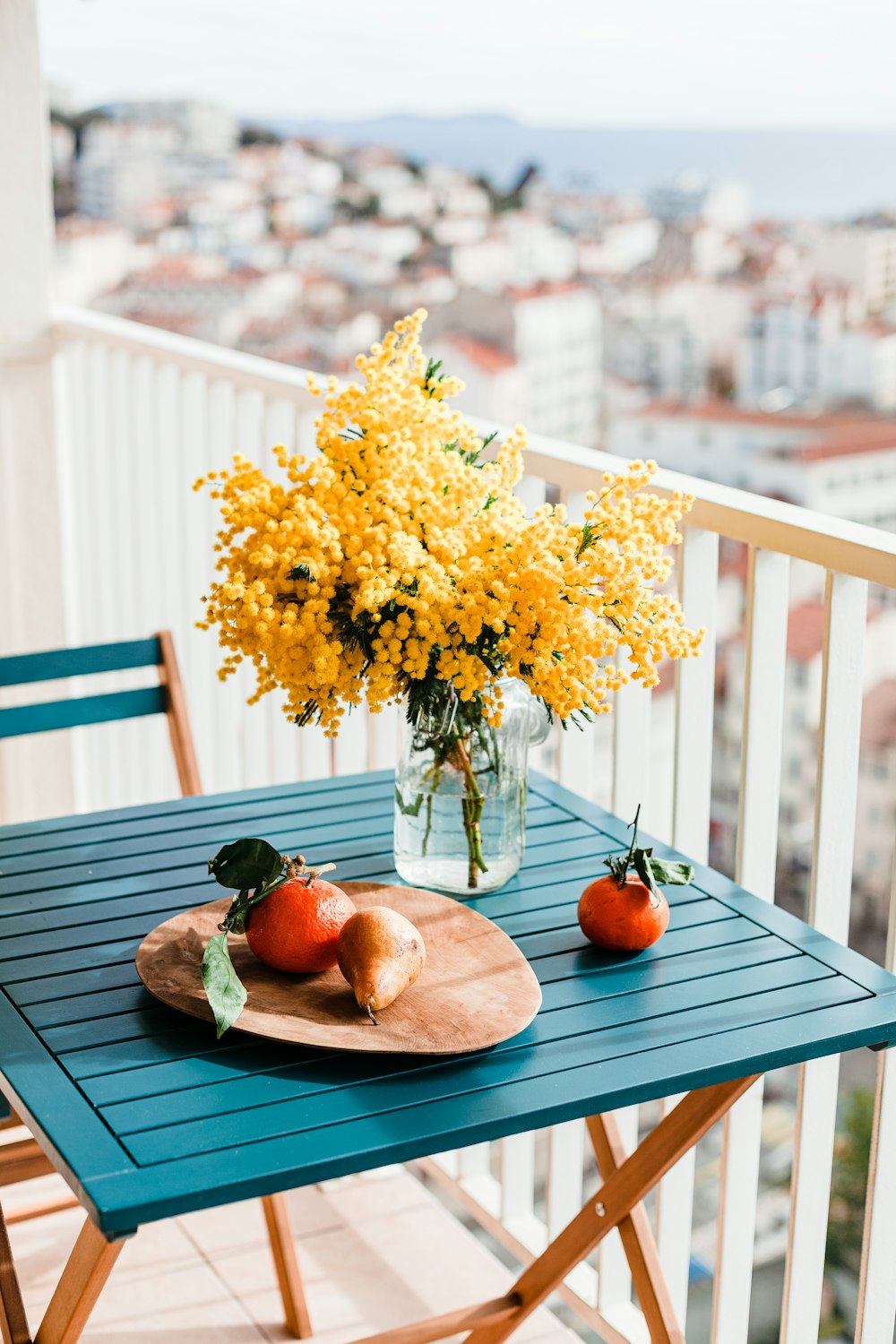 yellow flowers on brown wooden table