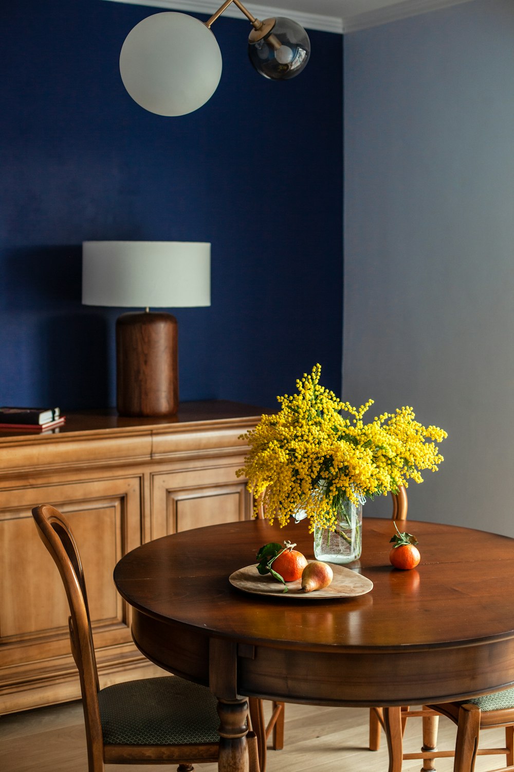 yellow flowers on brown wooden table