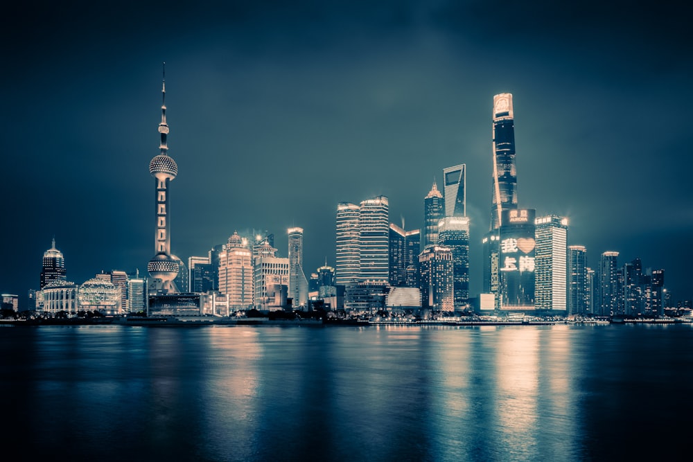 a city at night with lights reflecting off the water