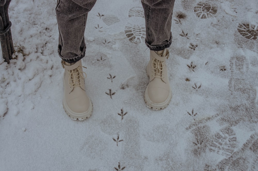 person in blue denim jeans and white shoes