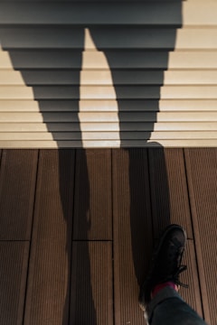 person wearing black leather shoes