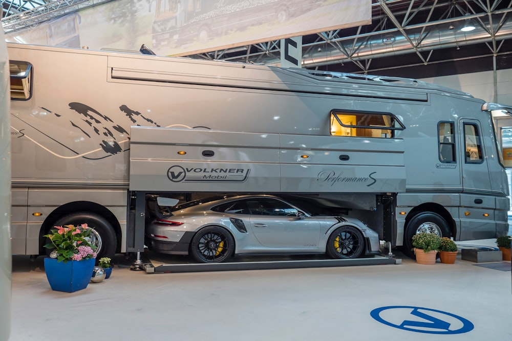 silver sedan parked beside white van