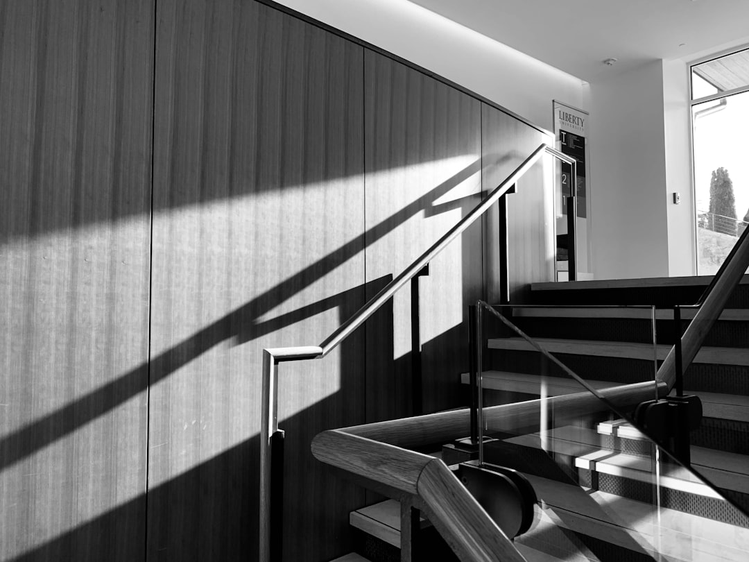 grayscale photo of staircase in room,