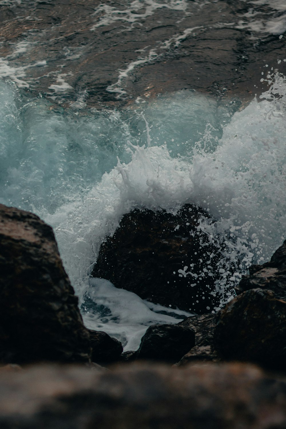 brown rock formation beside body of water during daytime