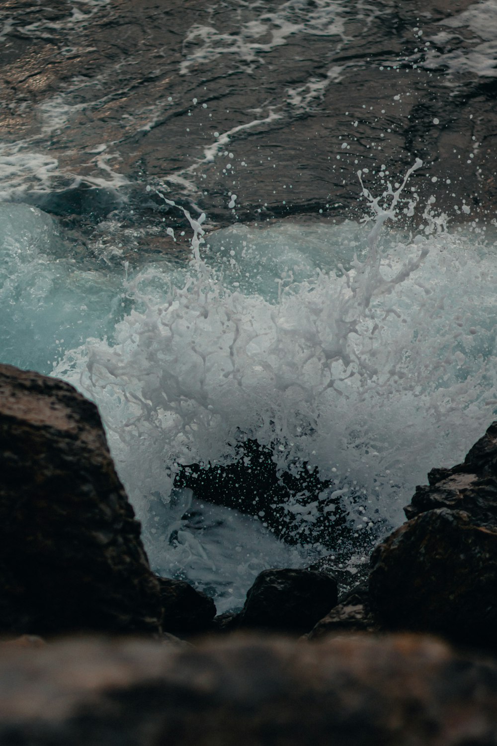 water waves hitting brown rock