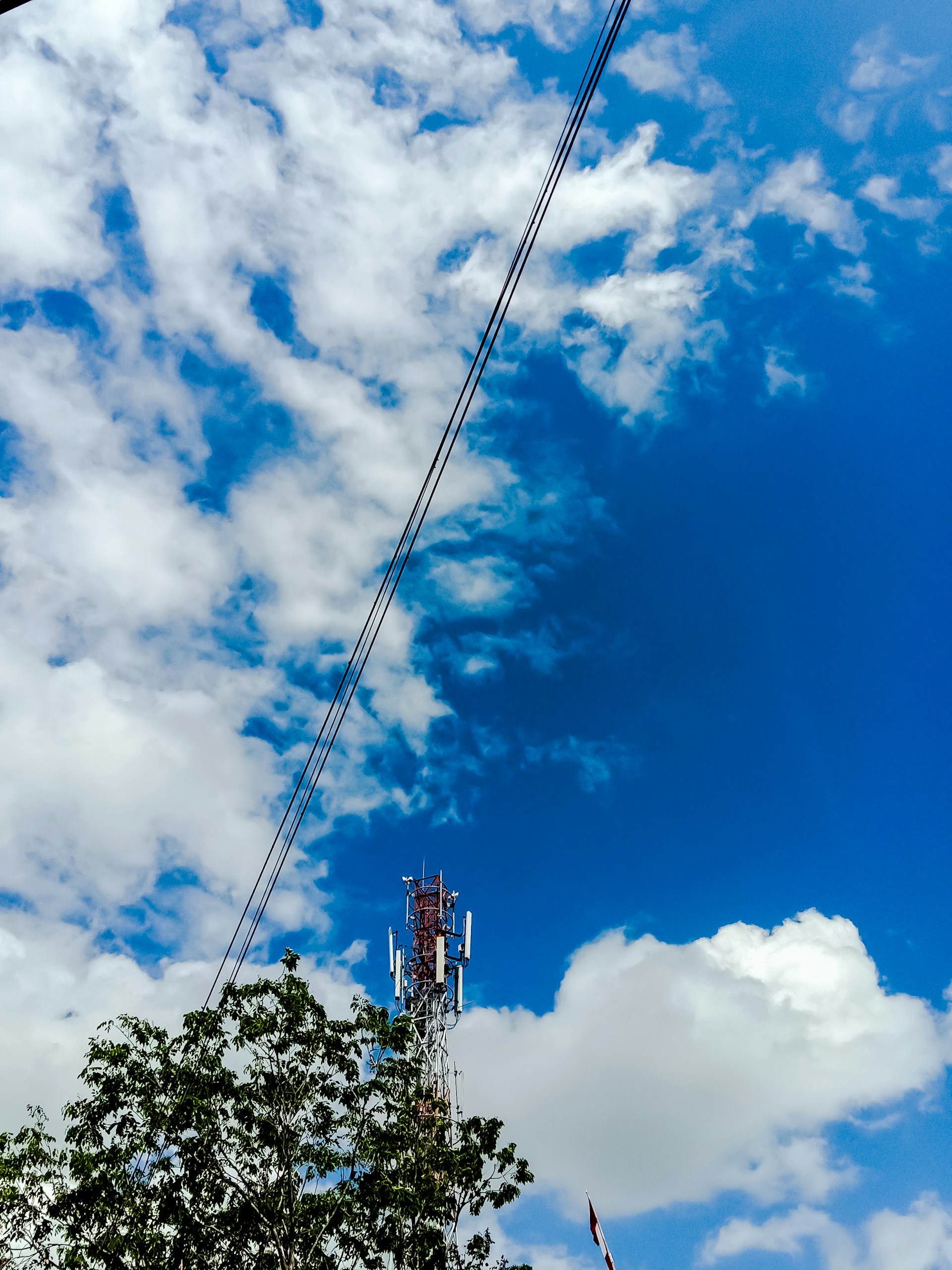 woman wearing yellow long-sleeved dress under white clouds and blue sky during daytime