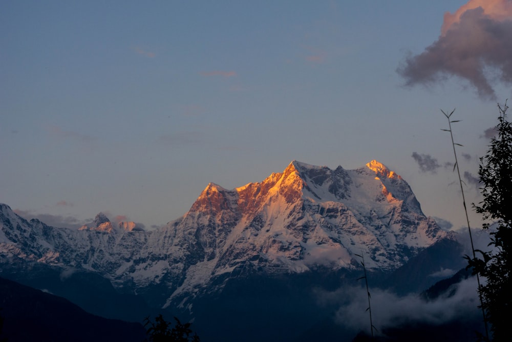 snow covered mountain under cloudy sky during daytime